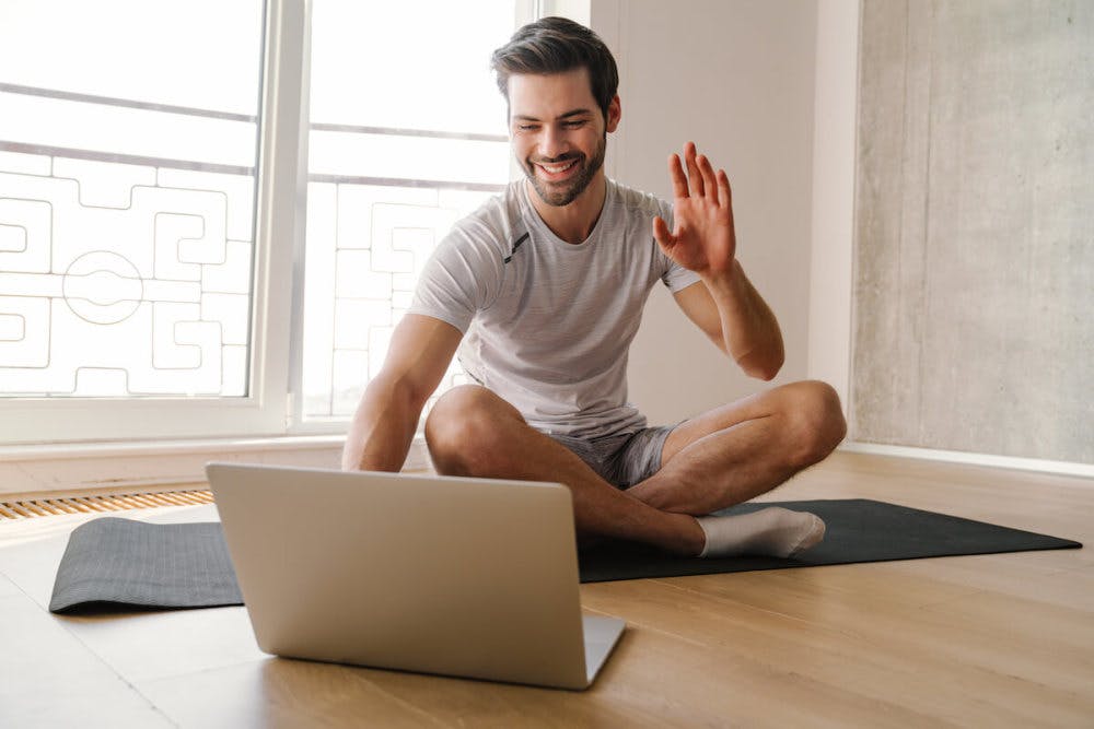 Man having a video call with his coach