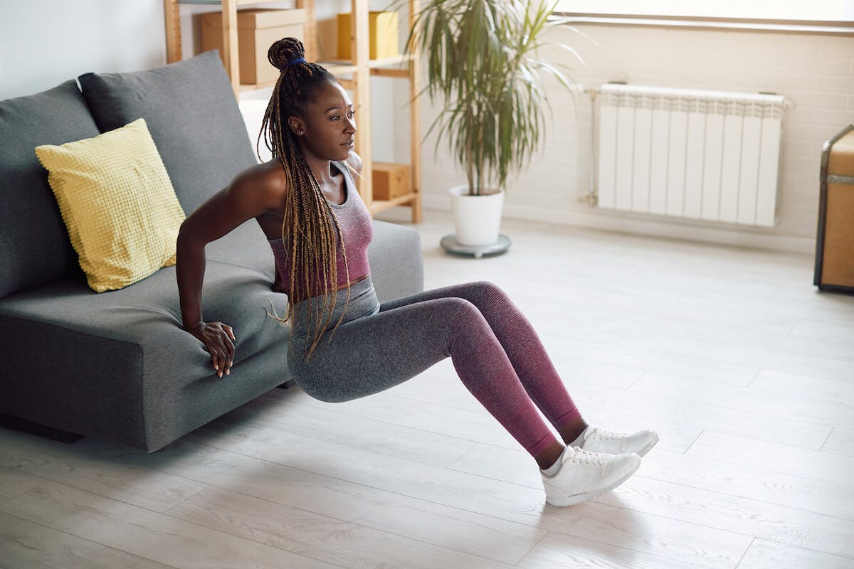 Compound exercises: person doing tricep dips at home