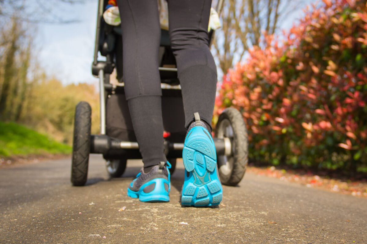 Postpartum exercise: person pushing a baby stroller